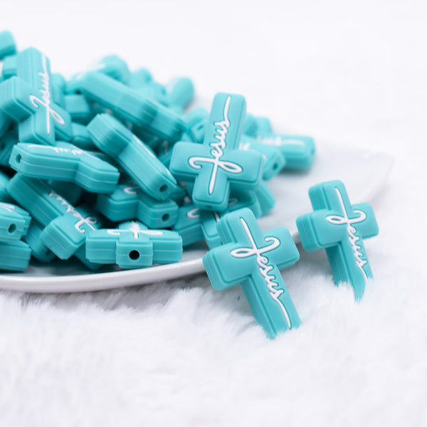 front view of Teal Cross Silicone Focal Bead Accessory