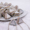 front view of a pile of 24mm Triangle Mother of Pearl with hanging Rhinestones bead