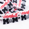 close up view of a pile of Volleyball Mom silicone focal bead