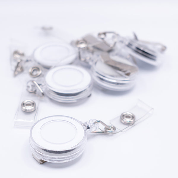 front view of a pile of White Badge Reel