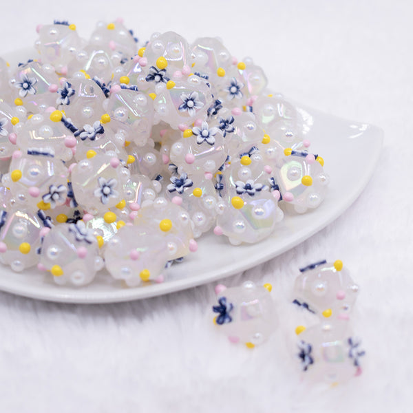 front view of a pile of 16mm White with Blue Flower luxury acrylic beads