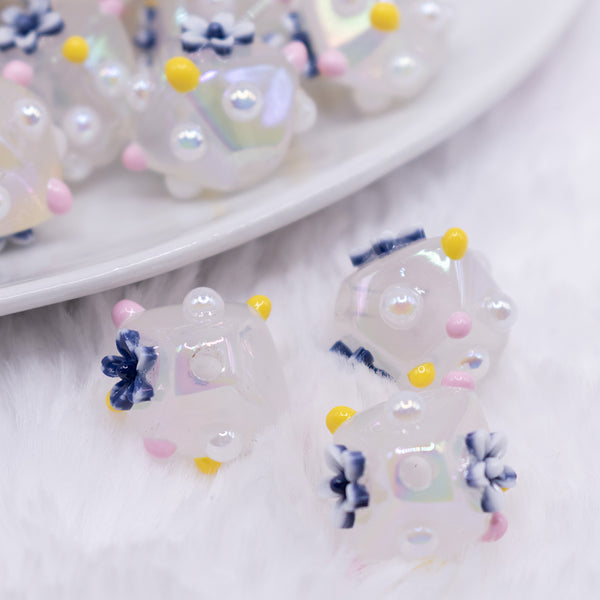 close up view of a pile of 16mm White with Blue Flower luxury acrylic beads