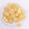 top view of a pile of 25mm Yellow Clover acrylic bead
