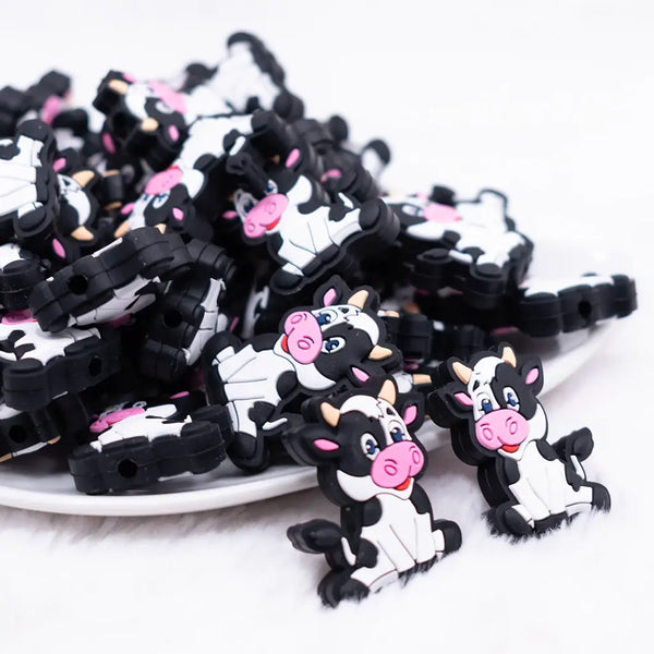 front view of a pile of Cow Silicone Focal Bead Accessory