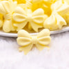 macro view of a pile of 25mm Cream Yellow Bow Knot silicone bead