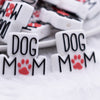 front view of a pile of Dog Mom with red Paw print Silicone Focal Bead Accessory