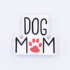 top view of a pile of Dog Mom with red Paw print Silicone Focal Bead Accessory