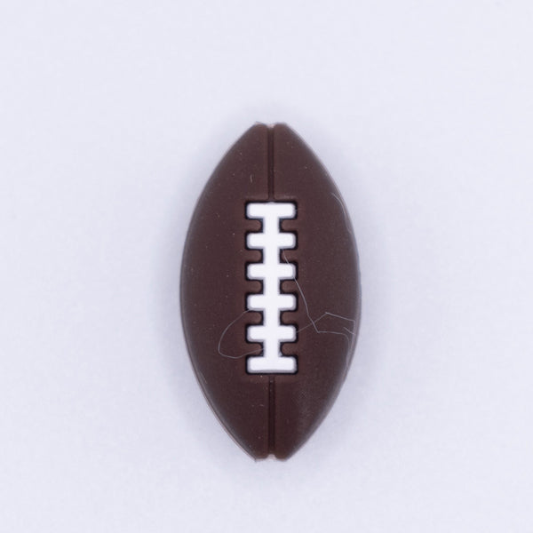 top view of a pile of Brown Football Silicone Focal Bead Accessory