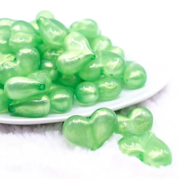 front view of a pile of 27mm Green Glitter Pearl Heart Acrylic Bubblegum Beads