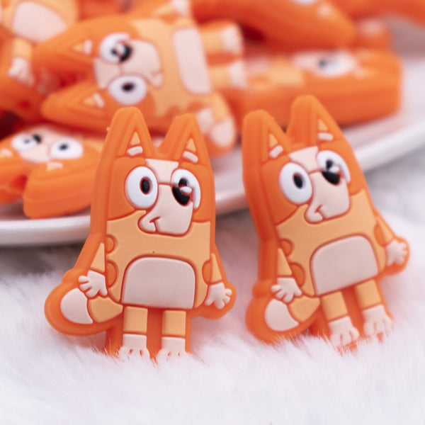 front view of a pile of Orange Dog Silicone Focal Bead Accessory