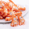top view of a pile of Orange Dog Silicone Focal Bead Accessory