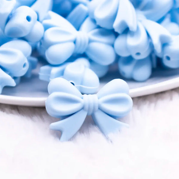 macro view of a pile of 25mm Pastel Blue Bow Knot silicone bead