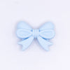 top view of a pile of 25mm Pastel Blue Bow Knot silicone bead