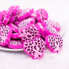 front view of a pile of Cancer Ribbon in Pink Leopard Heart Silicone Focal Bead Accessory