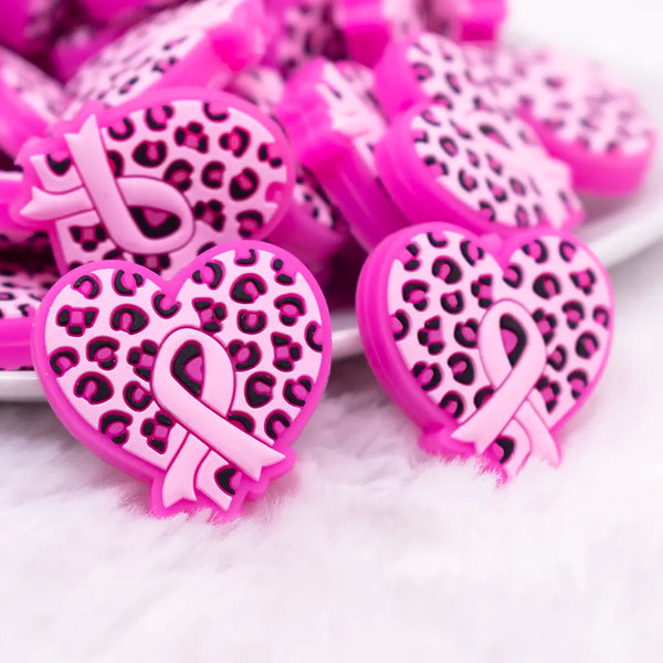 macro view of a pile of Cancer Ribbon in Pink Leopard Heart Silicone Focal Bead Accessory