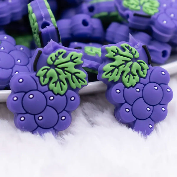 close up view of a pile of Purple Grape Silicone Focal Bead Accessory