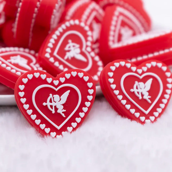 close up view of a pile of Red Cupid Heart Silicone Focal Bead