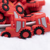 front view of a pile of Red Tractor Silicone Focal Bead Accessory