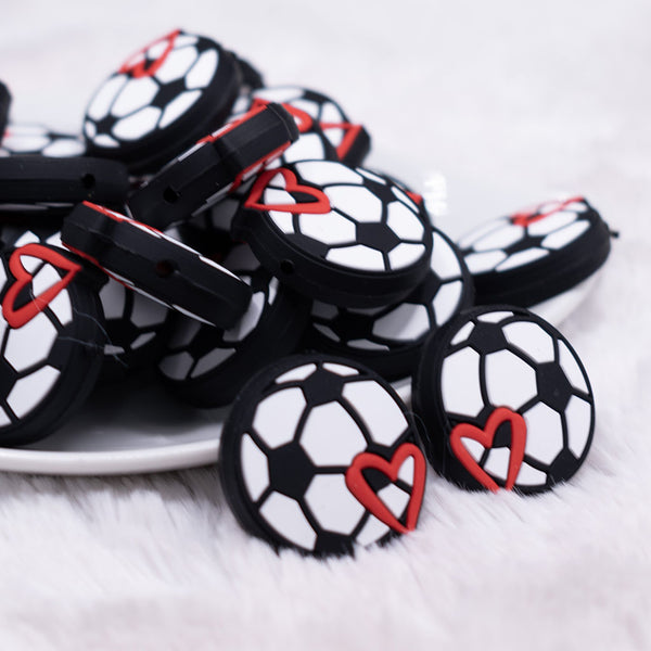 close up view of a pile of Soccer Silicone Focal Bead Accessory