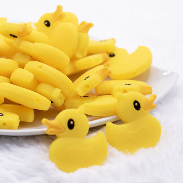 close up view of a pile of Yellow Ducky Silicone Focal Bead Accessory