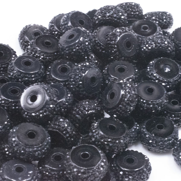 top view of a pile of 12mm Black Resin Rhinestone Rondelle Spacer Beads - Set of 10