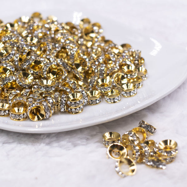 Front view of a pile of 10mm Gold Rondelle Large Hole Spacer Beads [Set of 20]