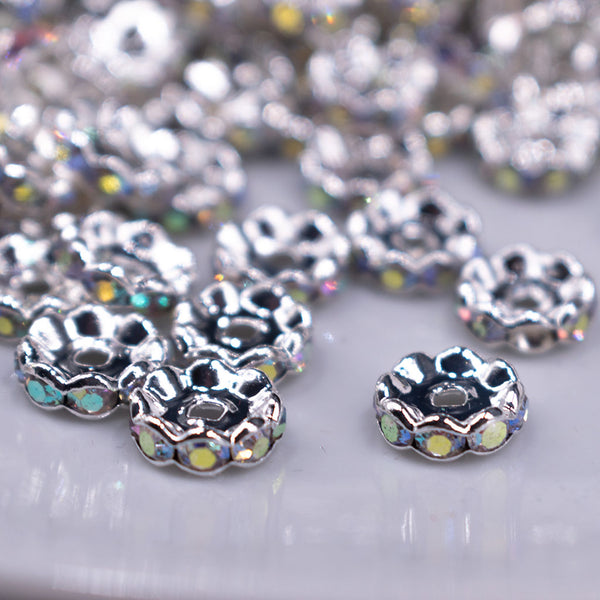 Front view of a pile of 10MM Wavy Silver Rondelle Spacer Beads [Set of 20]