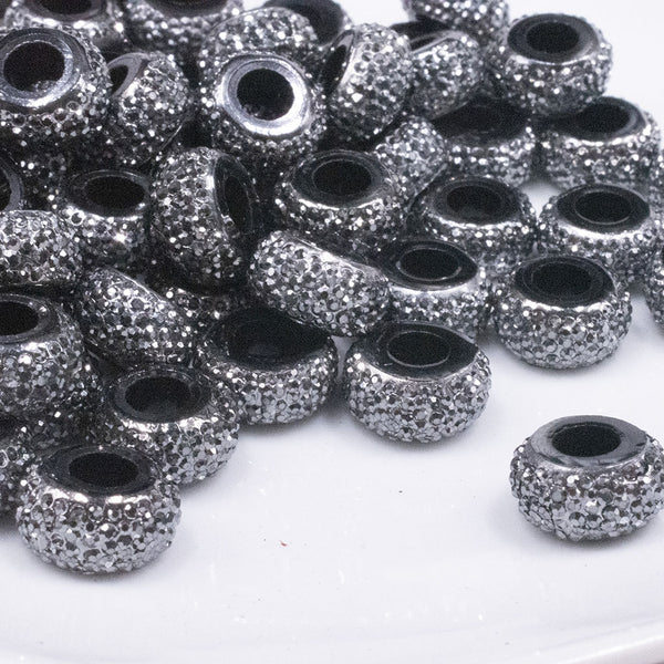 front view of a pile of 12mm Black Resin with Silver Rhinestone Rondelle Spacer Beads - Set of 10