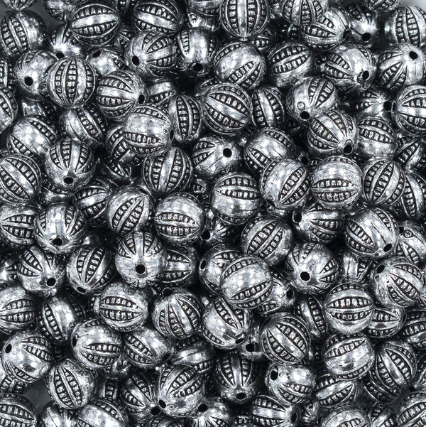 Close up view of a pile of 9mm Silver Antique Style Acrylic Beads