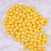 top view of a pile of 12mm Butter Yellow Solid Acrylic Bubblegum Beads - 20 & 50 Count