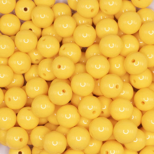 close up view of a pile of 12mm Butter Yellow Solid Acrylic Bubblegum Beads - 20 & 50 Count