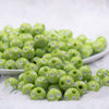 front view of a pile of 12mm Lime Green with White Polka Dot Acrylic Chunky Bubblegum Beads