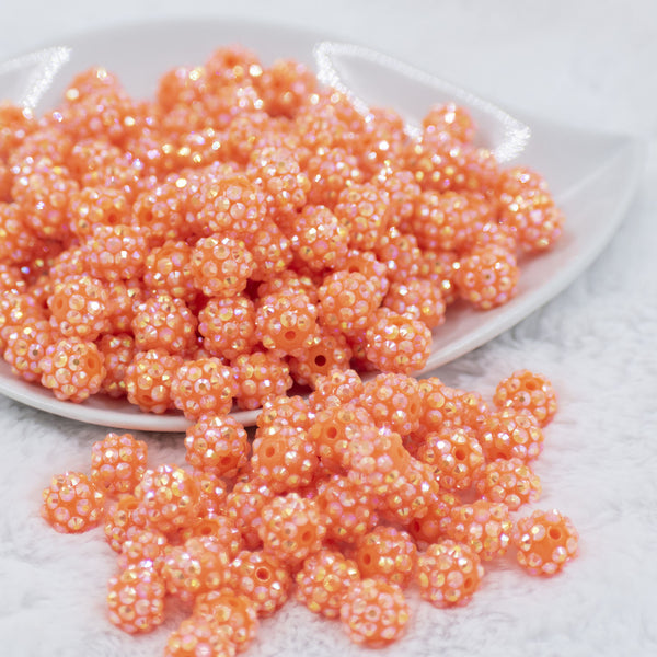 Front view of a pile of 12mm Orange Shimmer Rhinestone AB Bubblegum Beads [10 & 20 Count]