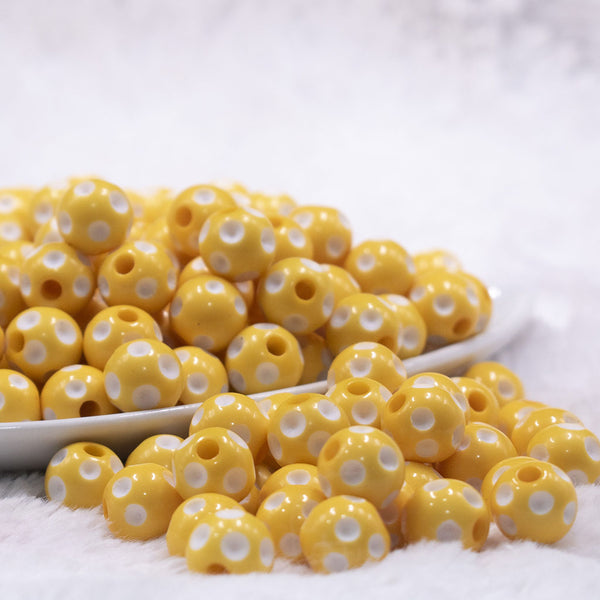 Front view of a pile of 12mm Yellow with White Polka Dot Acrylic Chunky Bubblegum Beads
