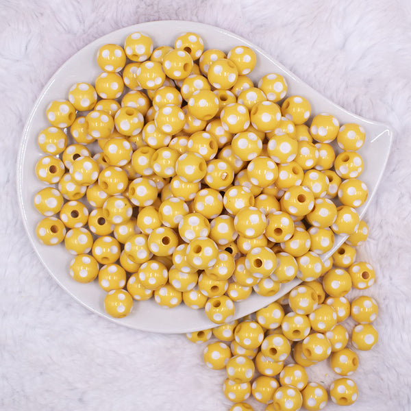 top view of a pile of 12mm Yellow with White Polka Dot Acrylic Chunky Bubblegum Beads