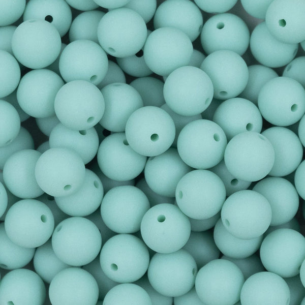 Close up view of a pile of 12mm Aqua Blue Matte Acrylic Bubblegum Beads