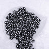 Top view of a pile of 12mm Black with White Polka Dot Acrylic Chunky Bubblegum Beads