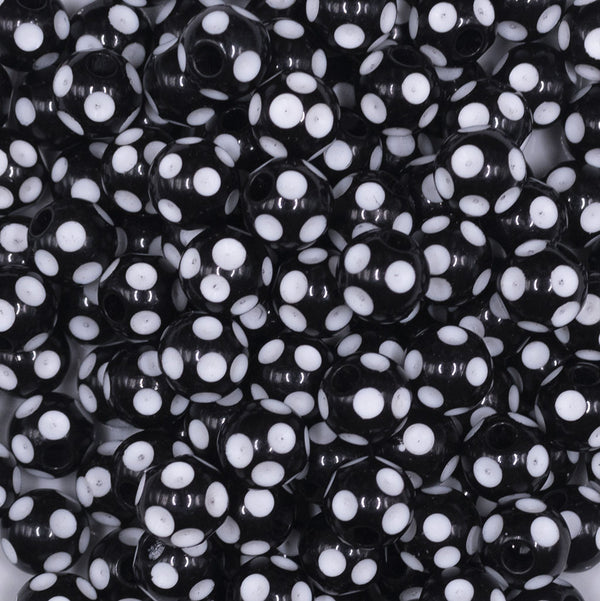 Close up view of a pile of 12mm Black with White Polka Dot Acrylic Chunky Bubblegum Beads