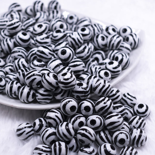 Front view of a pile of 12mm Black & White Zebra Print Chunky Acrylic Bubblegum Beads - 20 Count