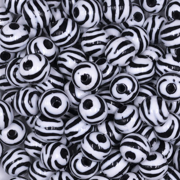 Close up view of a pile of 12mm Black & White Zebra Print Chunky Acrylic Bubblegum Beads - 20 Count