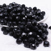 front view of a pile of 12mm Black Opaque Faceted Shaped Bubblegum Beads