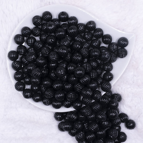 Top view of a pile of 12mm Black Opaque Pumpkin Shaped Bubblegum Bead