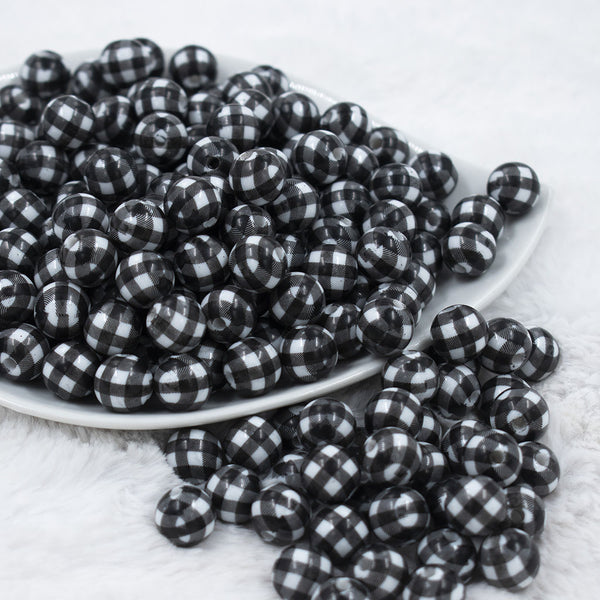 Front view of a pile of 12mm Black & White Plaid Print Chunky Acrylic Bubblegum Beads - 20 Count