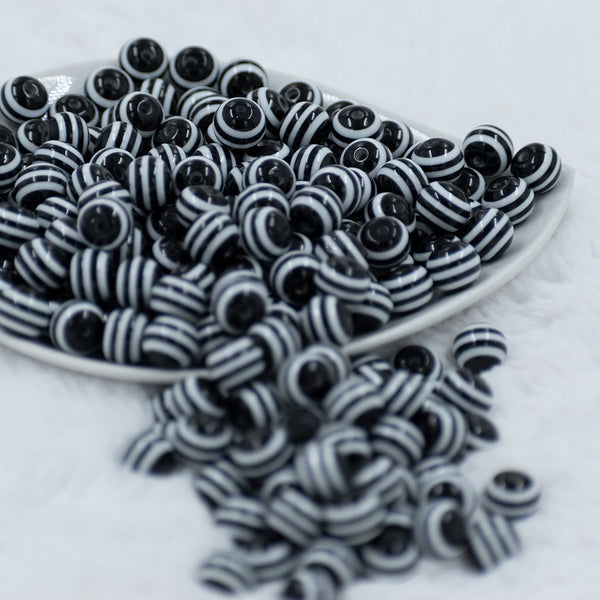Front view of a pile of 12mm Black with White Stripes Resin Chunky Bubblegum Beads