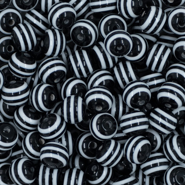 Close up view of a pile of 12mm Black with White Stripes Resin Chunky Bubblegum Beads