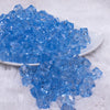 front view of a pile of 12mm Sky Blue Transparent Cube Faceted Bubblegum Beads