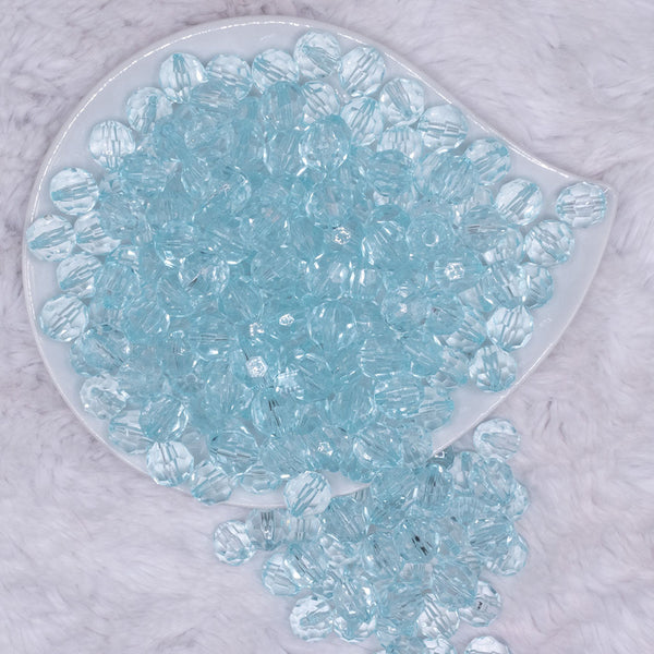 top view of a pile of 12mm Ice Blue Transparent Faceted Shaped Bubblegum Beads