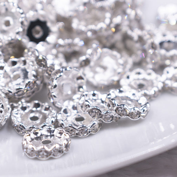 Macro view of a pile of 12MM Wavy Silver Rondelle Spacer Beads [Set of 10]