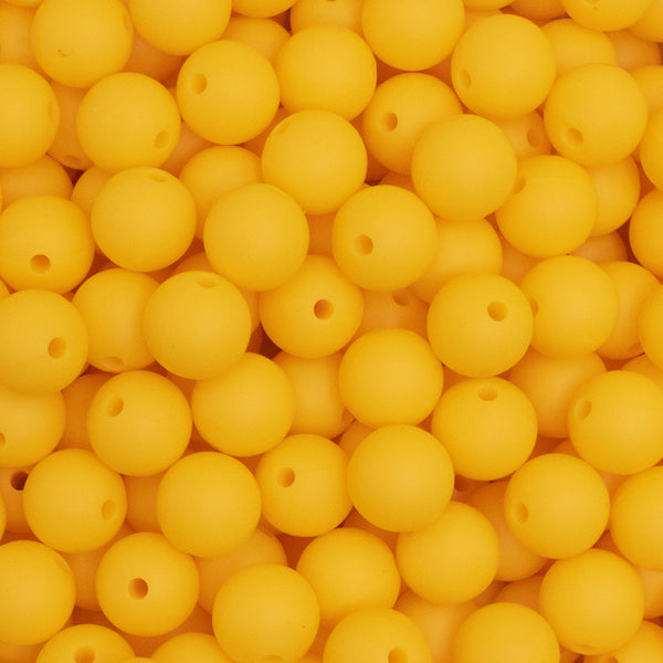close up view of a pile of 12mm Bright Yellow Round Silicone Bead