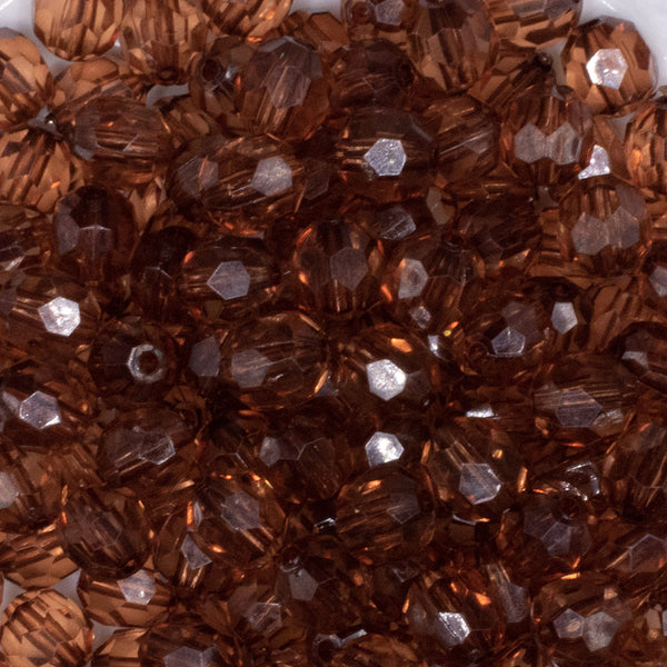 close up view of a pile of 12mm Brown Transparent Faceted Shaped Bubblegum Beads